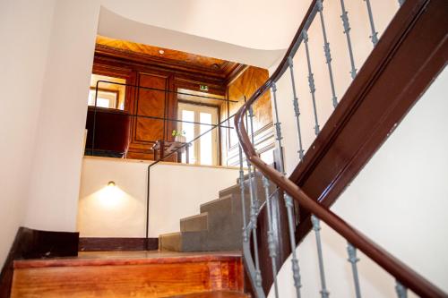 a staircase in a house with a light on it at Casa René - Charming apartments in Almada