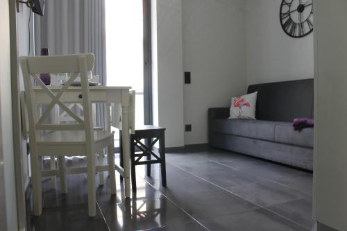 a living room with a table and a chair and a couch at Duque de Loulé - Apartments - Apartamento G in São Martinho do Porto