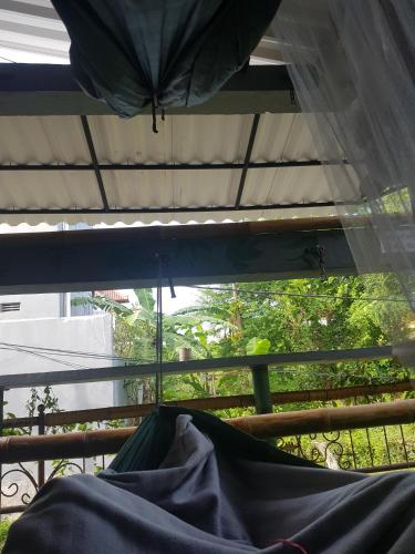 a view of a window with an umbrella at 24/7 Bed & Breakfast in Jimbaran