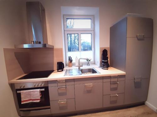 a kitchen with a sink and a window at Gemütliche Ferienwohnung Soltau in Soltau