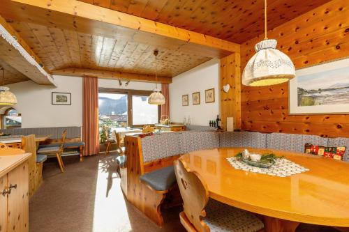 een keuken en eetkamer met een houten tafel bij Gästehaus Flora in Reit im Winkl