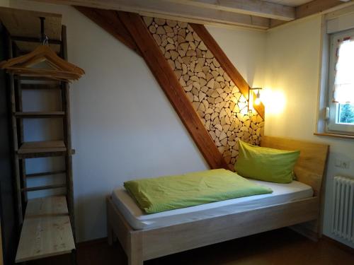 a bedroom with a bed with a wooden headboard at Lehmannshof Ferienwohnungen in Zell am Harmersbach
