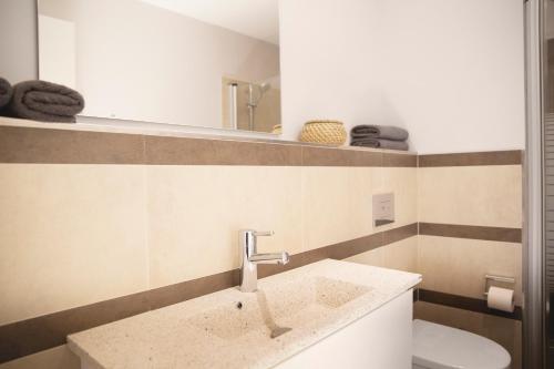 a bathroom with a sink and a toilet at Ferienwohnung Strandmuschel in Flensburg, Sonwik in Flensburg