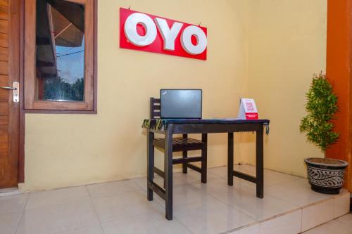 a laptop computer sitting on a desk in a room at OYO 2450 Hening Homestay Near Pantai Tanjung Bias in Montongbuwoh
