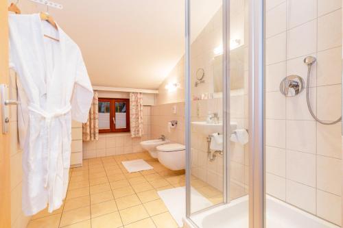 a bathroom with a shower and a toilet and a sink at Gästehaus Flora in Reit im Winkl