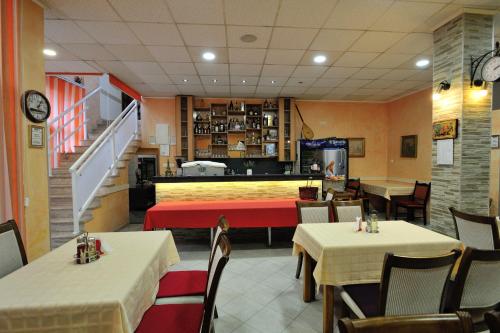 a dining room with tables and chairs and a restaurant at Motel Edem in Mostar