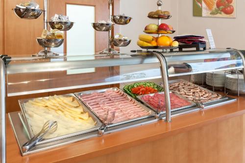 a buffet with meats and cheese and other foods at Augustus et Otto Hotel in Prague