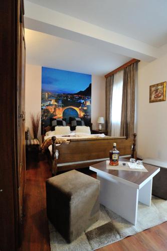 a living room with a bed and a coffee table at Motel Edem in Mostar