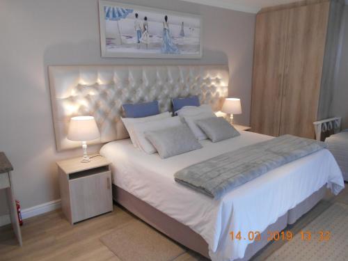 a bedroom with a large bed with lights on it at Splendida in Port Elizabeth