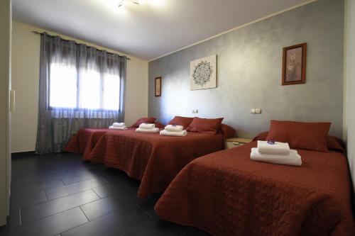 a hotel room with two beds with red sheets at LOS ALISOS in Coca