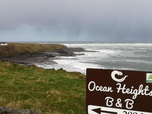 a sign on the side of a beach with the ocean at Ocean Heights B&B in Lissadell