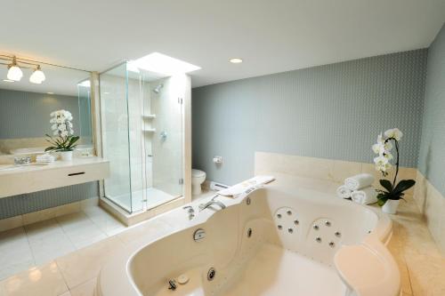 a large bathroom with a tub and a sink at Holiday Inn Niagara Falls-By the Falls, an IHG Hotel in Niagara Falls