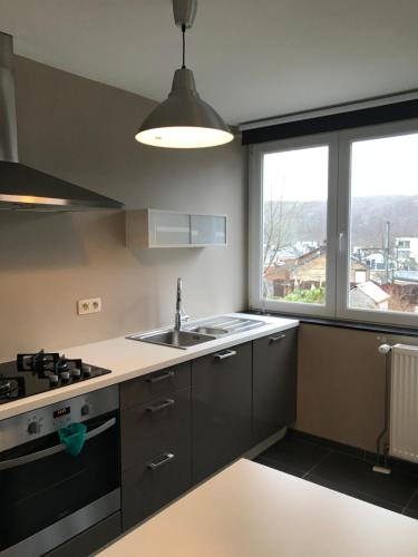 a kitchen with a sink and a stove at La Petite Villa in Spa