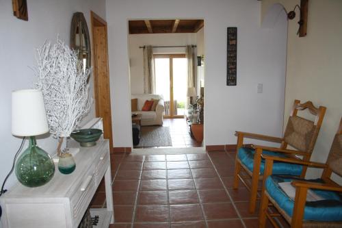 a living room with a couch and a table and chairs at Monte da Sapaleira in Aljezur
