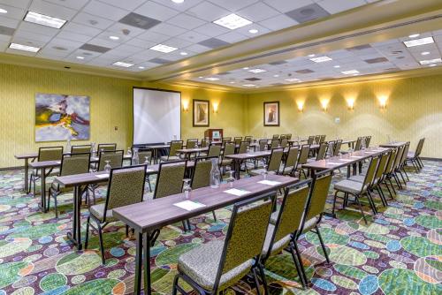 a conference room with tables and chairs and a whiteboard at Holiday Inn Indianapolis North-Carmel by IHG in Carmel