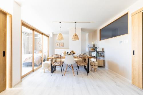 a dining room with a table and chairs at eni minamihorie Kaede in Osaka