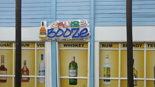a store front with bottles of alcohol on display at SandCastles Holiday #C9 in Ocho Rios
