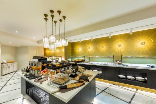 a large kitchen with a buffet of food at Catalonia Granada in Granada