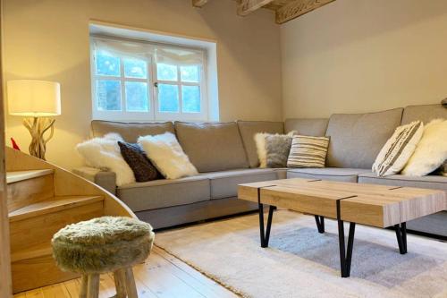 a living room with a couch and a coffee table at NEW Acogedor adosado en Salardu. in Salardú