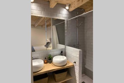 a bathroom with two sinks and a mirror at NEW Acogedor adosado en Salardu. in Salardú