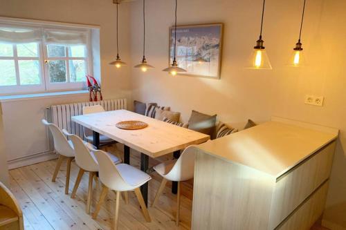 a dining room with a wooden table and chairs at NEW Acogedor adosado en Salardu. in Salardú