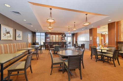 a restaurant with tables and chairs in a room at Holiday Inn Laramie by IHG in Laramie