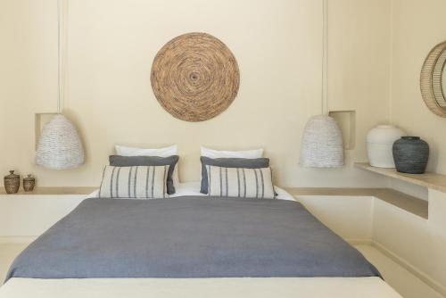 a bedroom with a large bed with two pillows at Verina Terra in Platis Gialos