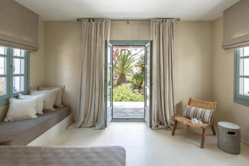 a bedroom with a bed and a sliding glass door at Verina Terra in Platis Gialos
