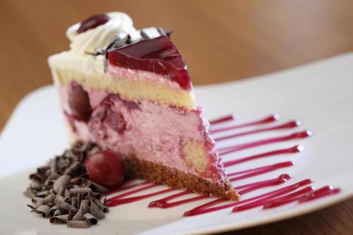 a piece of cake on a plate with a fork at Hotel Evropa in Celje