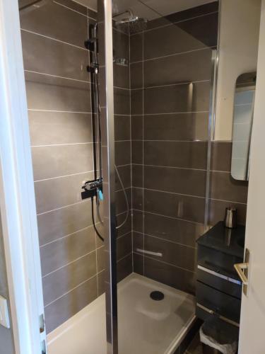 a shower stall in a bathroom with a toilet at Le Mémorial apparthotel-GoodCaen in Caen