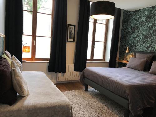Кровать или кровати в номере Le Relais DUCAL - Appartements d'Hôtes Vieille Ville