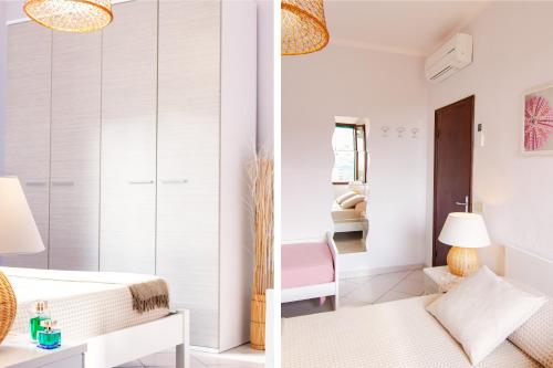 a white bedroom with a bed and a chair at Casa Gelso in Marciana