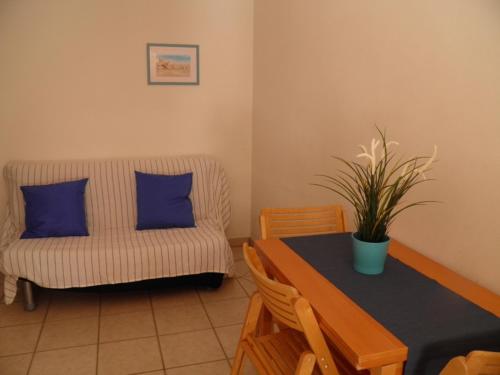 a living room with a table and a couch at MaremMare Tuscany Apartments in Principina a Mare