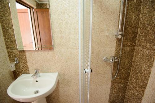 a bathroom with a sink and a shower at Vila Moecel in Moieciu de Sus