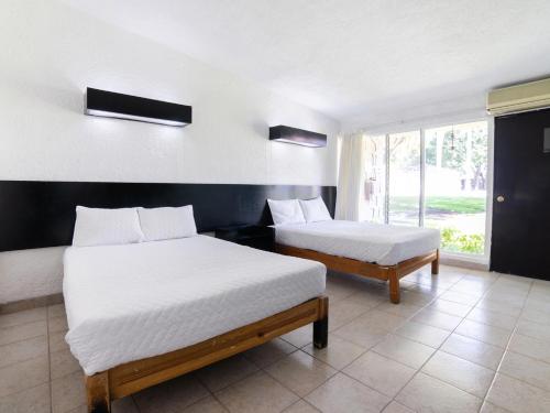 En eller flere senge i et værelse på Hotel Teques Palace