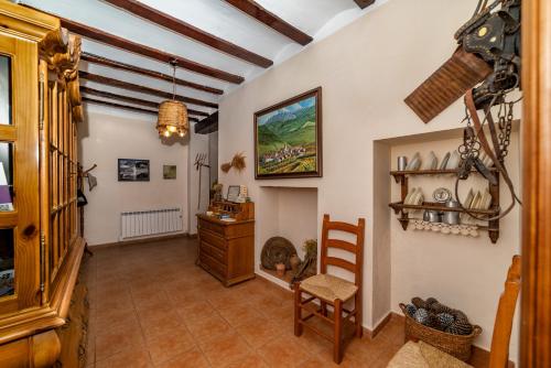 a hallway with a table and a chair in a room at Terra Blanca del Benicadell in Beniatjar