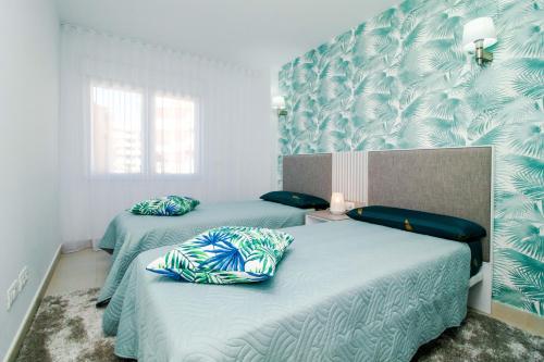 トレビエハにあるEspanatour YULIANAの青と白の壁紙を用いた客室内のベッド2台