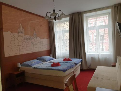 a bedroom with a bed with red shoes on it at Aaron in Prague