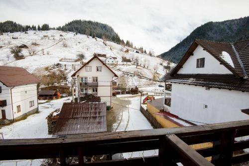 a view of a town with snow covered buildings at Vila Moecel in Moieciu de Sus
