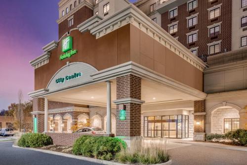 a hotel with a sign on the front of a building at Holiday Inn Lafayette-City Centre by IHG in Lafayette