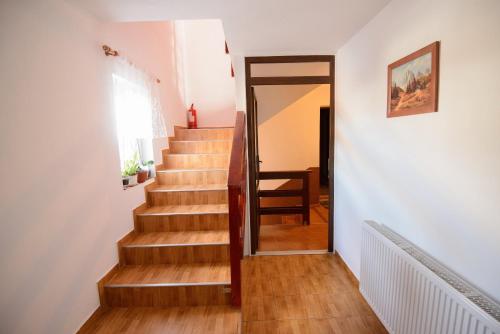a staircase in a house with a mirror and a door at Vila Moecel in Moieciu de Sus