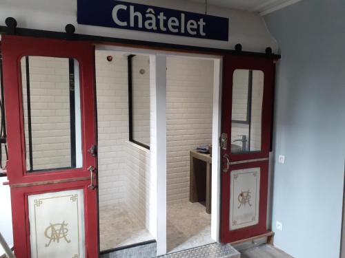 an entrance to a building with two red doors at ancienne maison des templiers in Gouillons