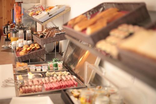 a buffet line with many different types of food at Hôtel Brésil Opéra SPA in Paris