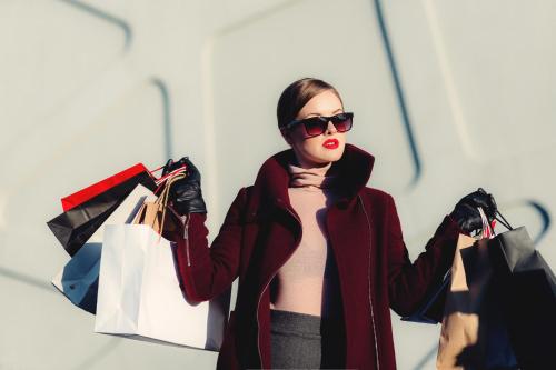 a woman holding shopping bags in her hands at Holiday Inn London - Regent's Park by IHG in London