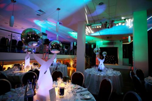 a bride and groom are holding up balloons in a room at Holiday Inn London Camden Lock by IHG in London