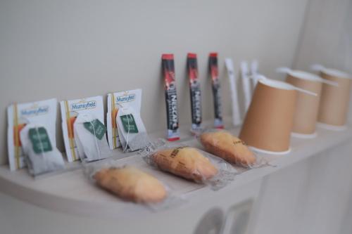 a shelf with some food in bags on it at Hôtel Brésil Opéra SPA in Paris