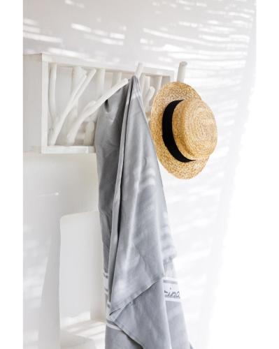 a straw hat is hanging on a rack at Verina Terra in Platis Gialos