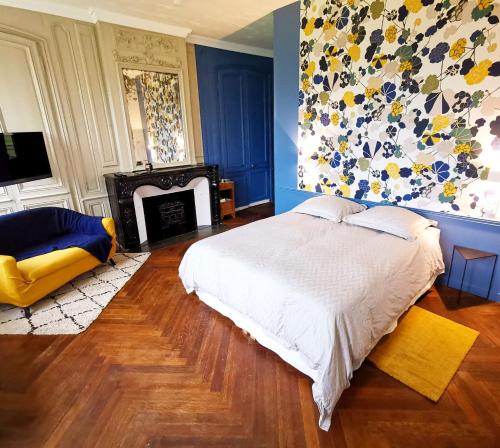 una camera con letto e camino di Manoir des Carreaux Chambres d'hôtes a Ingouville