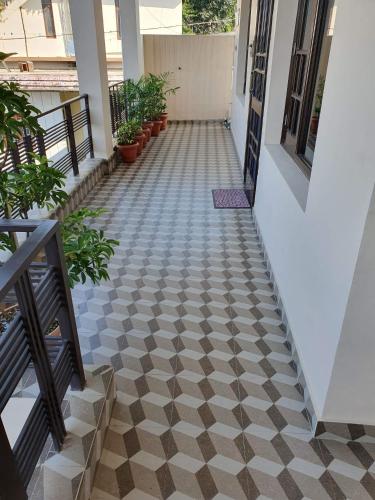 a hallway of a house with a checkered floor at Touristen Holiday Home A luxury Villa in Dharamshala