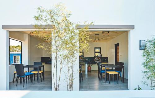 a dining room with black tables and chairs at Rold and Roub Home Suites powered by Cocotel in Puerto Galera